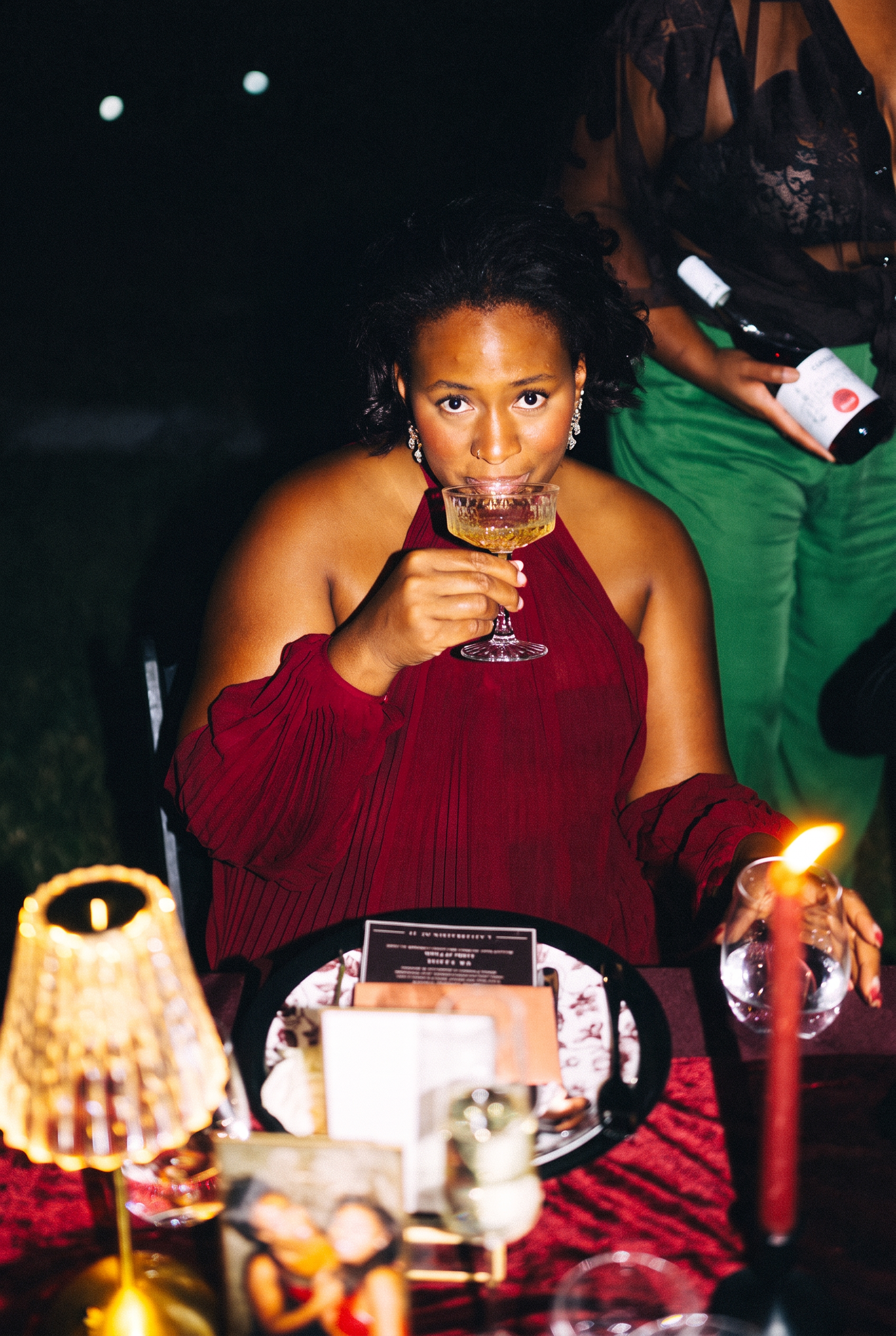 Symone sipping a glass of wine at the candlelit Dinner I table